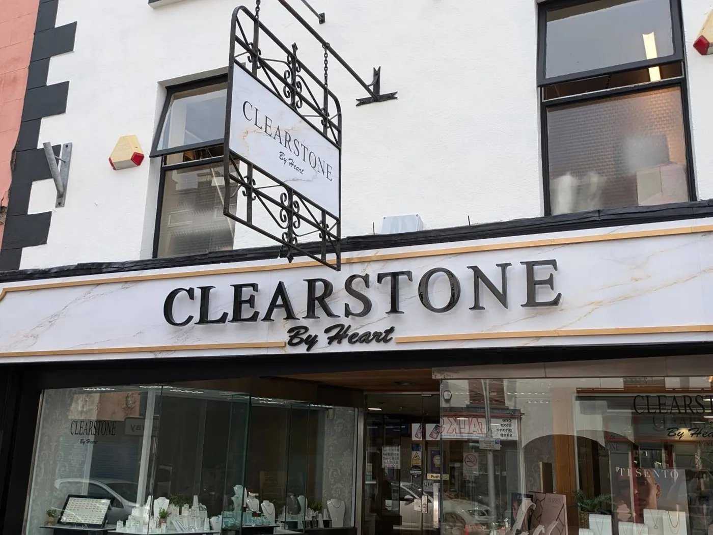 Clearstone by Heart jewellery shop front with a wrought-iron hanging sign and marble-effect fascia lettering.