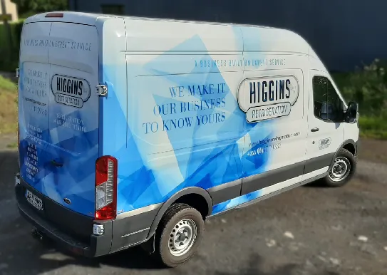 Higgins Refrigeration commercial van with full colour vehicle graphics parked outside a premises.