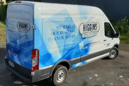 Higgins Refrigeration delivery van finished in a full blue and white vinyl wrap.