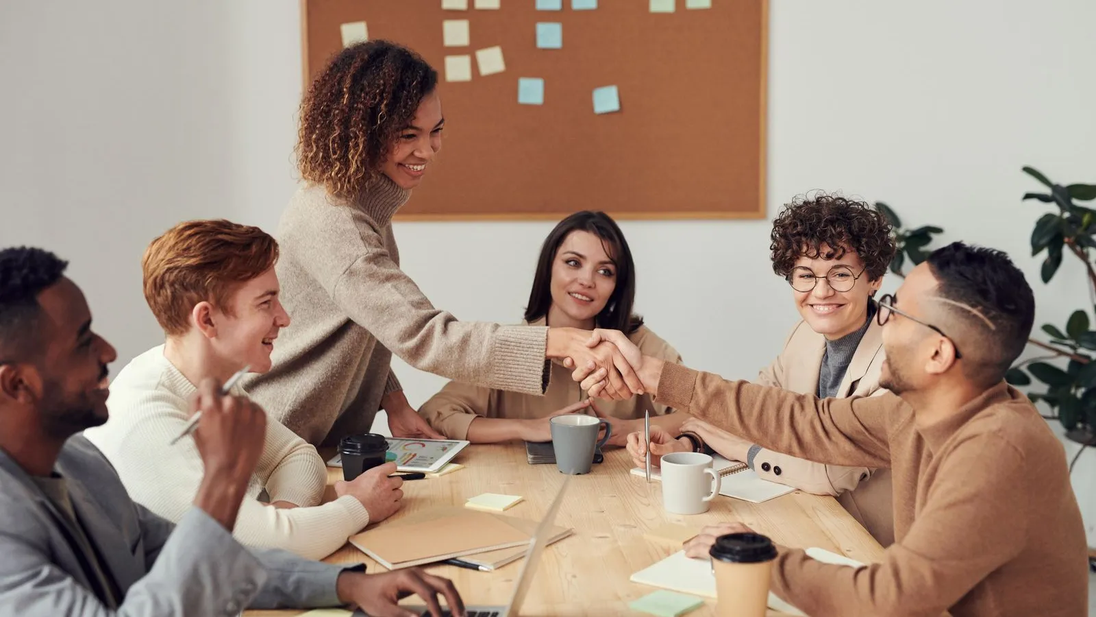 Placeholder image (Pexels): a team around a table in a bright meeting room. Client photography to follow.