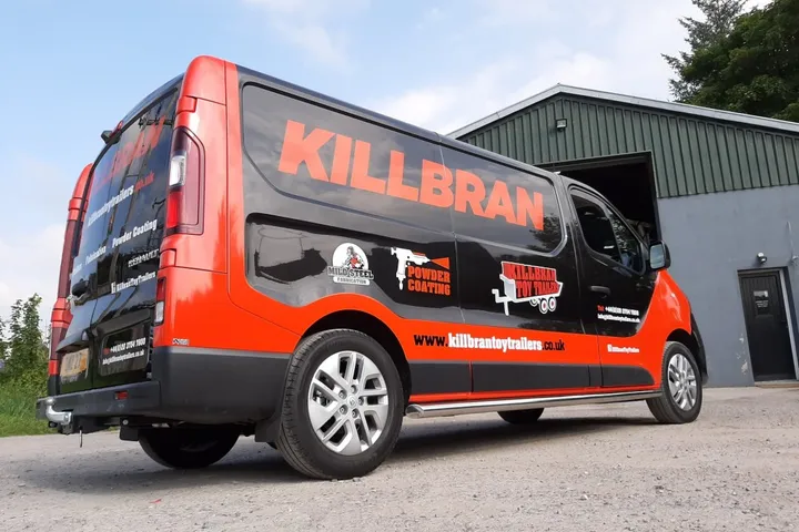Killbran Toy Trailers box van finished in a black and orange vinyl wrap, parked outside their Mid Ulster workshop.
