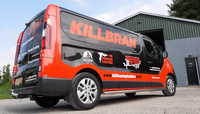 Killbran Toy Trailers box van finished in a black and orange vinyl wrap, parked outside their Mid Ulster workshop.