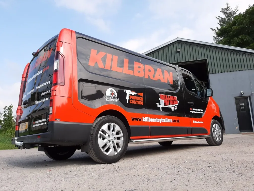 Killbran Toy Trailers box van finished in a black and orange vinyl wrap, parked outside their Mid Ulster workshop.