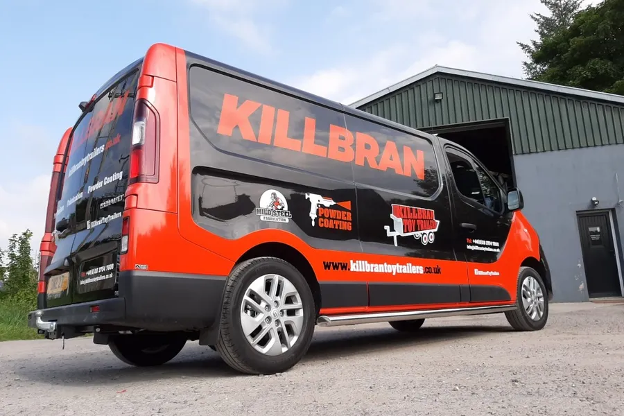 Killbran Toy Trailers box van finished in a black and orange vinyl wrap, parked outside their Mid Ulster workshop.