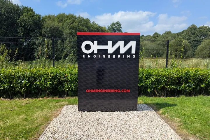 OHM Engineering freestanding illuminated totem sign at the entrance to their site.