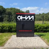 OHM Engineering freestanding illuminated totem sign at the entrance to their site.