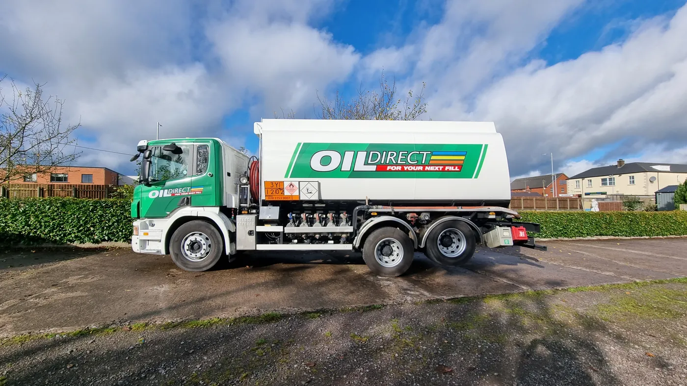 Oil Direct fuel tanker in green and white livery, parked on a rural road.