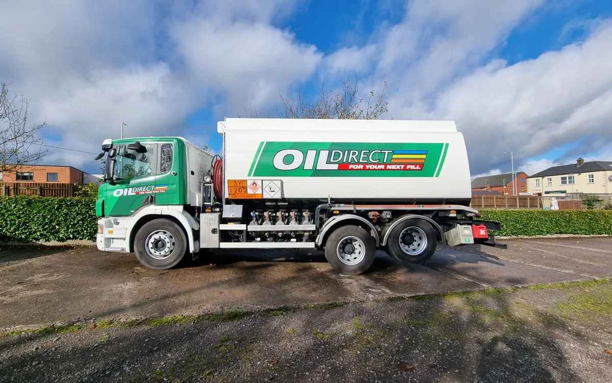 Oil Direct fuel tanker in green and white livery, parked on a rural road.
