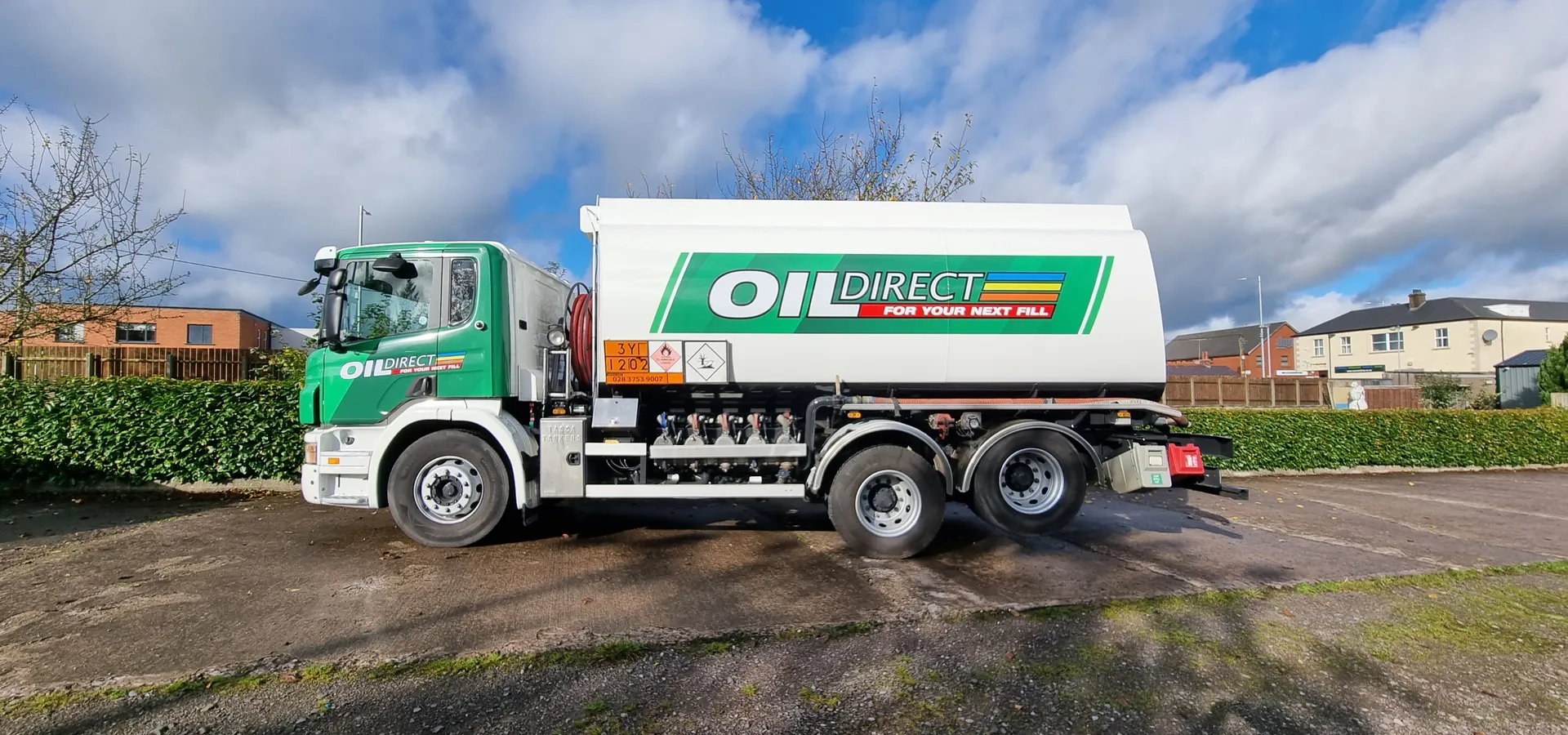 Oil Direct fuel tanker in green and white livery, parked on a rural road.