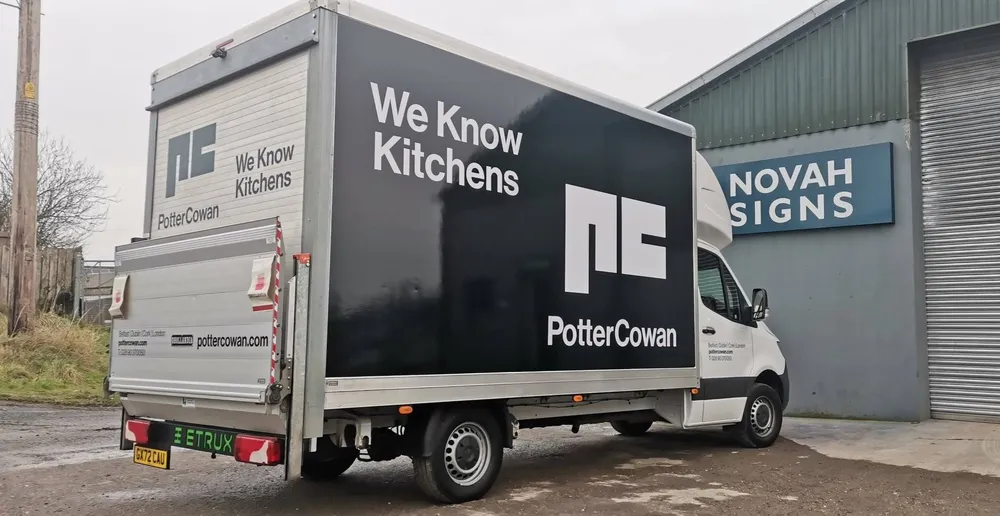 Potter Cowan box truck with a full vehicle wrap reading 'We Know Kitchens', photographed outside the Novah Signs workshop.
