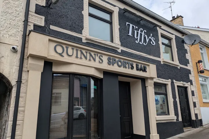 Quinn's Sports Bar building with raised dimensional fascia lettering above the entrance.