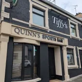 Quinn's Sports Bar building with raised dimensional fascia lettering above the entrance.
