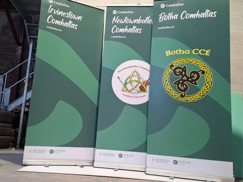 Three roll-up banners for Comhaltas branches (Irvinestown, Newtownbutler and Botha) finished in green branded artwork.