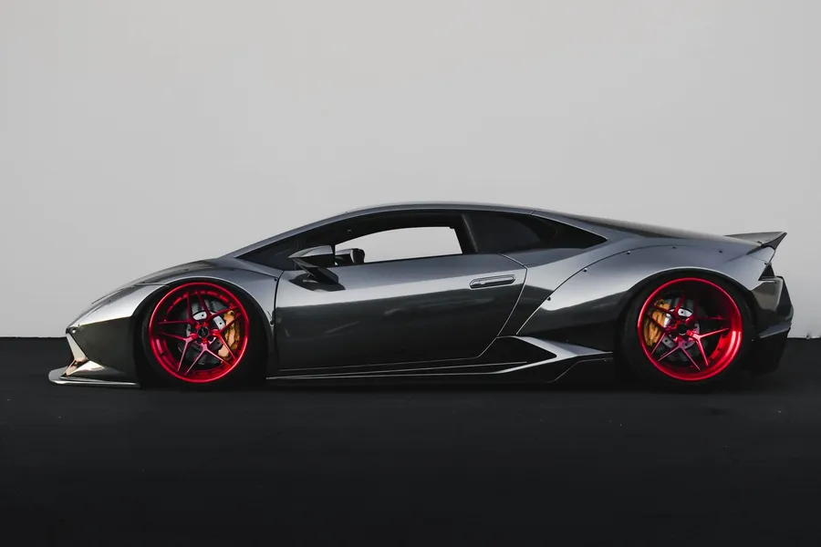 Placeholder image (Pexels): a sports car on a wet road at dusk. Client photography to follow.